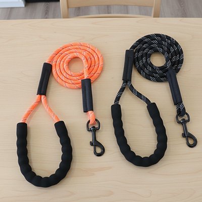 longe pour chien orange et noir sur table